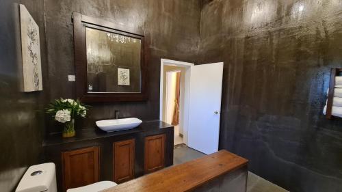 a bathroom with a sink and a toilet at Unique Furnished Holiday Villa Bahrain 