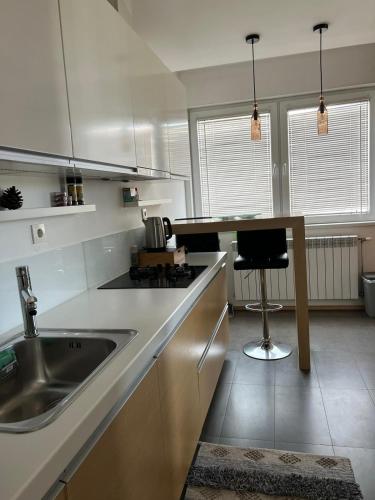 a kitchen with a sink and a counter top at Modern apartment in Skopje in Skopje