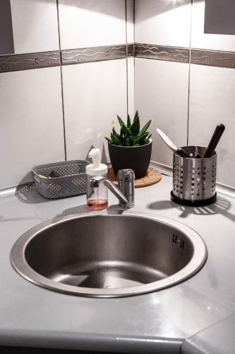 a sink in a kitchen with some pots and pans at To-Ten in Radom