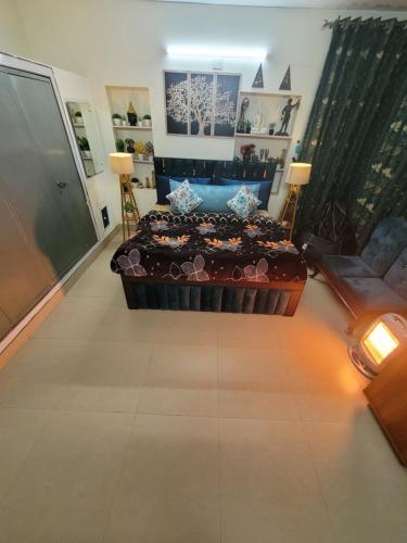 a living room with a bed and a couch at Dhairya's Villa Home Away From Home in Jammu