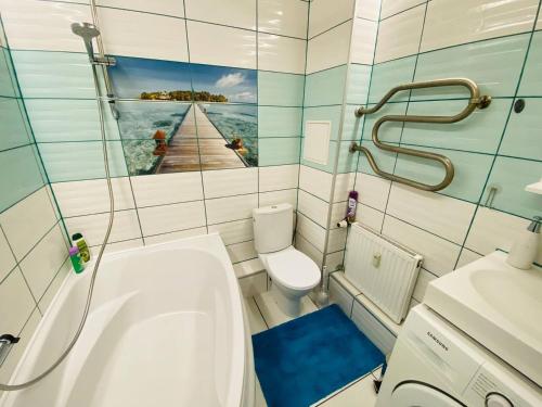 a small bathroom with a sink and a toilet at Coastal Comfort Apartments in Liepāja