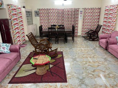 a living room with a couch and a table at Dhairya's Villa Home Away From Home in Jammu
