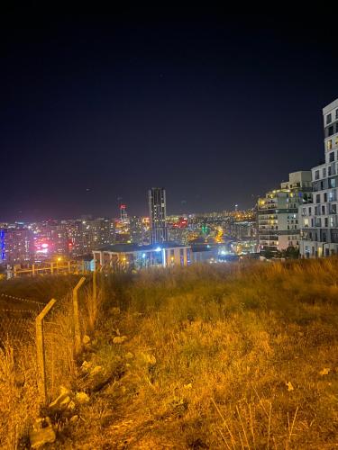 a view of a city at night with lights at Kamp çadır tesisi in Buyukcekmece