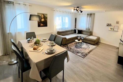 a living room with a table and a couch at Im Herzen der Altstadt in Vaihingen an der Enz