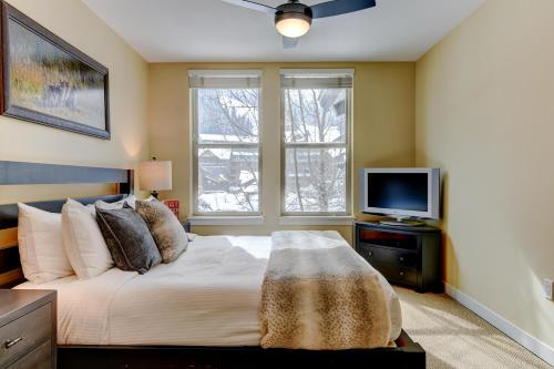 a bedroom with a large bed and a television at Ski In-Out Luxury Condo #4283 With Huge Hot Tub & Great Views - 500 Dollars Of FREE Activities & Equipment Rentals Daily in Winter Park