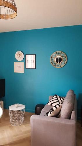 un mur bleu avec un canapé dans le salon dans l'établissement Studio cosy au coeur du centre historique, à Montpellier