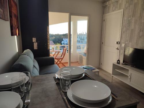 a living room with a table with plates on it at Apartamento Gala 1 in Cala en Blanes