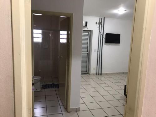 a hallway with a door leading to a bathroom at Pousada dos Eletricitarios in Praia Grande