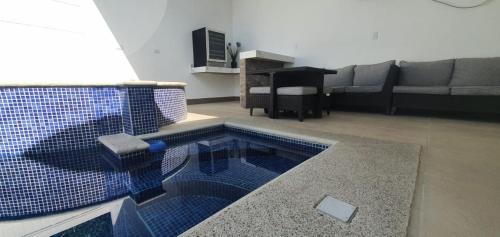 a living room with a pool in the middle of a room at Casa de playa con piscina y jacuzzi privado in Puntarenas