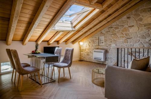 a living room with a vaulted ceiling with a skylight at Cambiello Bella Casa in Corfu Town