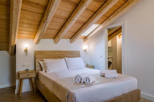 a bedroom with a bed with two towels on it at Cambiello Bella Casa in Corfu Town