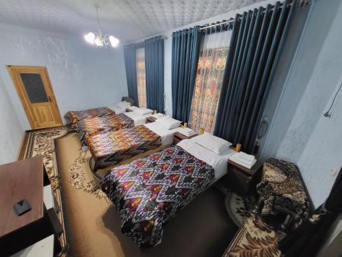 an overhead view of a room with three beds at Hotel Motrid in Samarkand