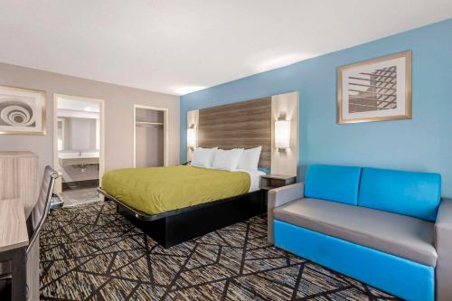 a hotel room with a bed and a couch at Quality Inn in Newberry