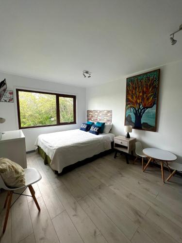 a bedroom with a bed and a large window at Hare Mahatu in Hanga Roa