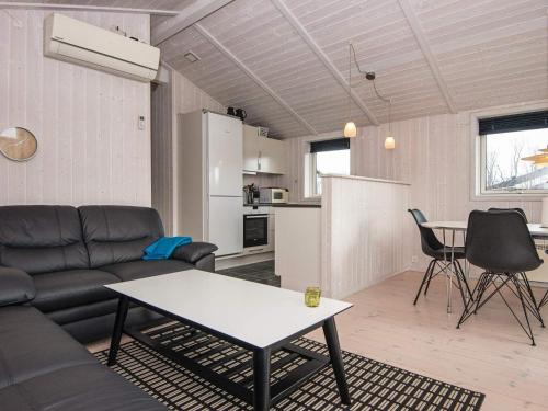a living room with a couch and a table at 6 person holiday home in Juelsminde-By Traum in Sønderby