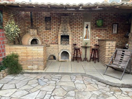 a brick building with a brick fireplace in a patio at Casa Sol nascente in Triunfo