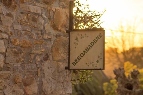 a sign on the side of a stone wall at Bekoabadene in Menaka