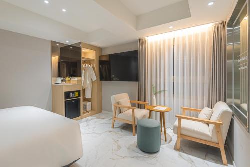 a bedroom with a bed and a table and chairs at Asherah Villa d' aqua Hotel in Gimhae