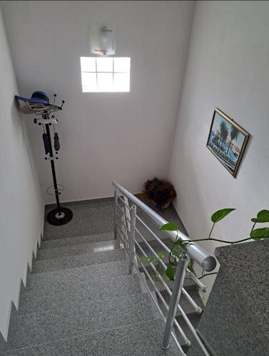 a stairway with a light and a tripod in a room at Beautiful duplex apartment with view in Kaštela