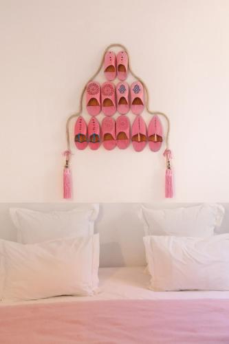 a bedroom with a rack of shoes on the wall at Riad Amya & Spa in Marrakech