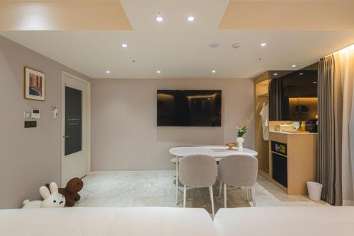 a kitchen with a table and chairs in a room at Asherah Villa d' aqua Hotel in Gimhae
