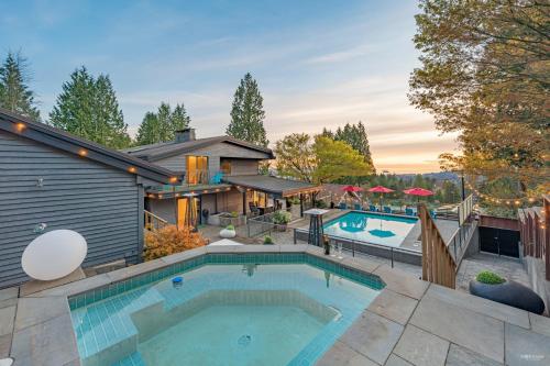 a house with a swimming pool in the backyard at Seymour Private Bedroom, Ensuite Bathroom with Shared Pool, Hot Tub with Views in North Vancouver