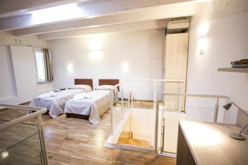 a hospital room with three beds in a room at Hotel Arezzo ASC in Arezzo