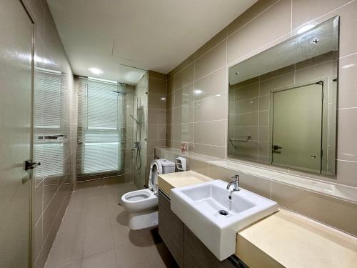 a bathroom with a sink and a toilet and a mirror at KGS HOME at Sutera Avenue Kota Kinabalu Area KK City Opposite Imago in Kota Kinabalu