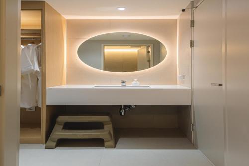 a bathroom with a sink and a mirror at Asherah Villa d' aqua Hotel in Gimhae