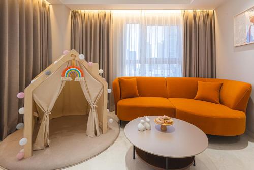 a living room with a couch and a childs play area at Asherah Villa d' aqua Hotel in Gimhae