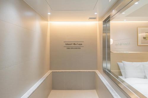 a room with a bed and a sign on the wall at Asherah Villa d' aqua Hotel in Gimhae