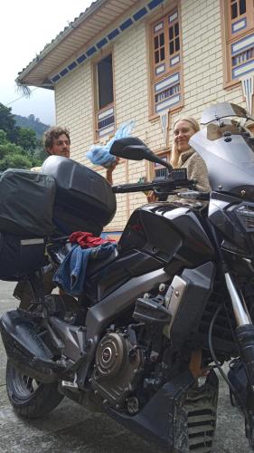 a group of people standing next to a motorcycle at HOSTAL CASA VICTORIA PIJAO in Pijao