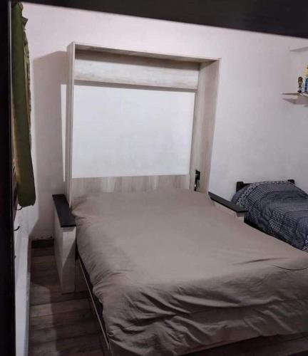 a bed in a bedroom with a window at Carlina I in Salta