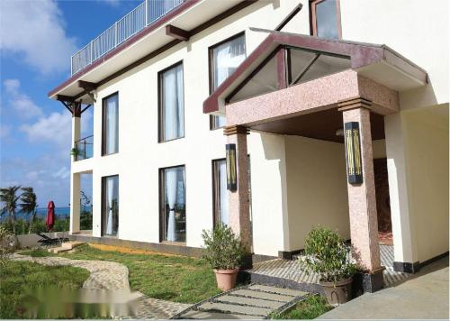 a white house with a lot of windows at Hanamitsu Hotel & Spa in Garapan