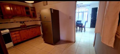 a kitchen with a stainless steel refrigerator in a room at Casa centro Mendoza patio asador in Las Heras