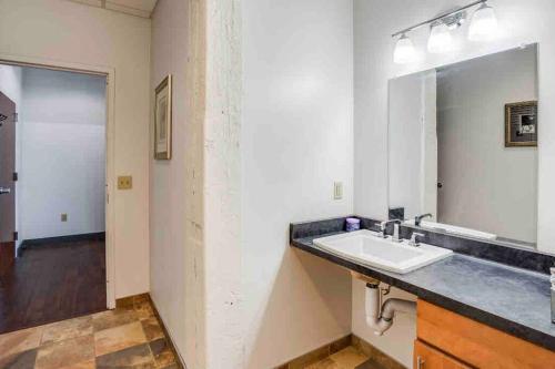 a bathroom with a sink and a mirror at NY Style Centric Loft with King Bed by Park av in Rochester