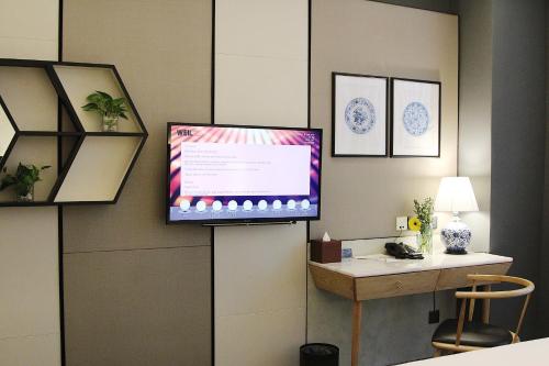 a flat screen tv on a wall in a room at WEIL Hotel Ipoh in Ipoh