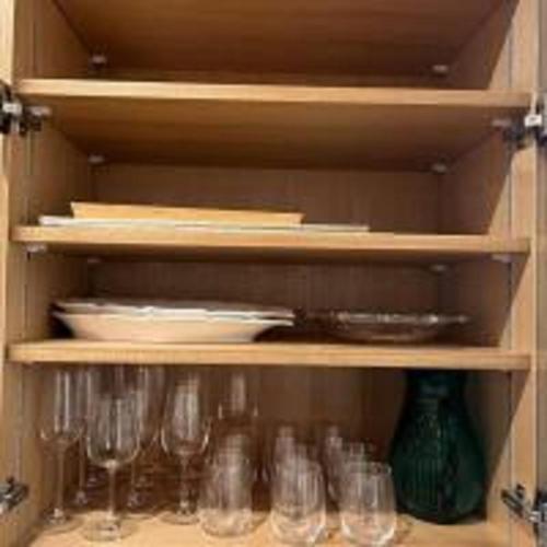 a cupboard filled with glasses and plates and dishes at Beachside base KURUWA in Yokosuka