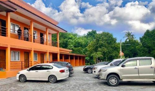 a group of cars parked outside of a building at At Sichon Resort in Sichon