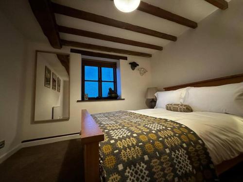 a bedroom with a large bed and a window at Hay On Wye Welsh Townhouse in Hay centre in Hay-on-Wye
