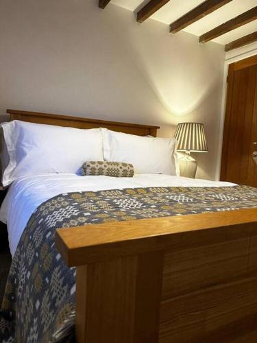 a bedroom with a large bed with a wooden headboard at Hay On Wye Welsh Townhouse in Hay centre in Hay-on-Wye