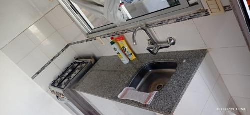 eine kleine Küche mit einem Waschbecken und einem Spiegel in der Unterkunft Apto. en Colonia, a 1 cuadra de la Plaza de Toros in Colonia del Sacramento