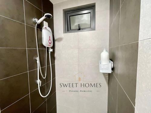 a bathroom with a shower with a blow dryer on the wall at Blue Studio Suite 1-4pax B'Worth Prai@SwimmingPool in Perai