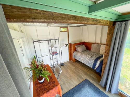 a small room with a bed and a table at Gingerhill Farm Retreat in Kealakekua