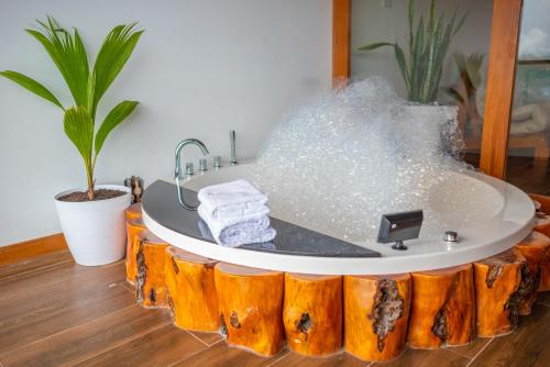 a bathroom with a bathtub made out of wood at Riosol Hotel Laguna Azul in Sauce