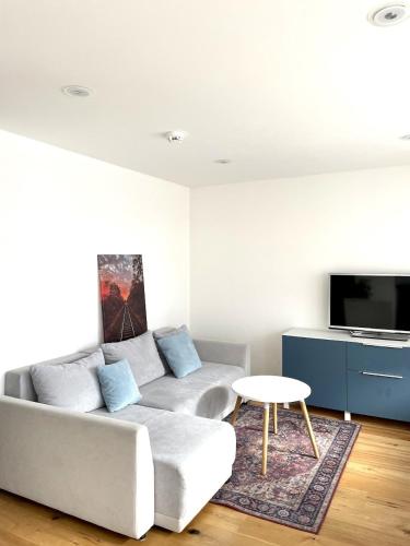 a living room with a couch and a table at LYMA Suites - Studio S25 in Immenstadt im Allgäu