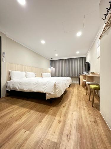 Postel nebo postele na pokoji v ubytování Yoshi Hotel - Tainan Station Branch