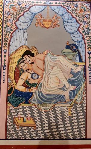 a painting of a woman laying on a bed at Hotel Shekhawati Haveli in Mandāwa