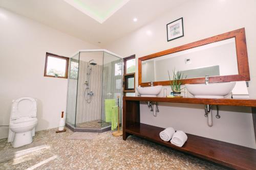 a bathroom with a sink and a toilet at Denika's Suites in Puerto Princesa City