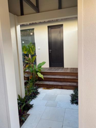 a front door of a house with plants at Serenity Villas Rarotonga in Rarotonga